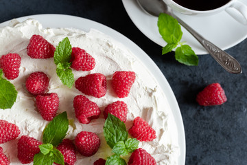 Meringue with whipped cream, raspberries.and mint