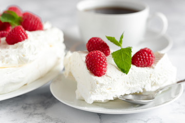 Meringue with whipped cream, raspberries.and mint