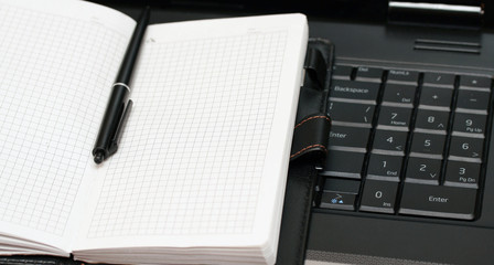 note book lies on the black keyboard