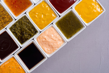 Set of different sauces in ceramic bowl