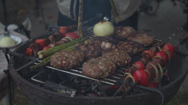 Outdoor grill with beef and vegatables in slow motion. 