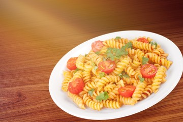 Pasta fusilli with bolognese tomato beef sauce on the kitchen table