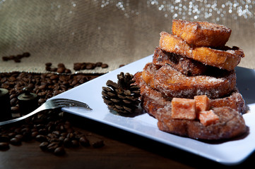 Sweet bread, milk, egg, known as Brazilian french toast. Traditional at Christmas dinner. Torrijas, traditional in spanish holy week. White dish background. Seen up close.Horizontal.
