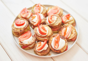 fried zucchini with tomatoes and sour cream sauce
