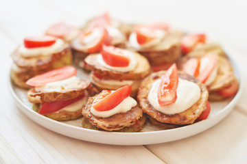 fried zucchini with tomatoes and sour cream sauce