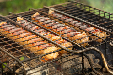 Grilled Sausages On The Grill. Cooking in the fresh air. Concept: outdoor recreation, delicious, natural food, relaxation and entertainment.