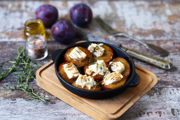 Baked plums with feta cheese. French cuisine Healthy organic food.