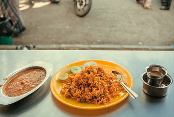 Rice with spices and vegetables in Indian style. Traditional food with curry for customer of street cafe in city of India