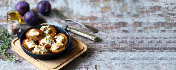 Obraz na płótnie Canvas Baked plums with feta cheese. French cuisine Healthy organic food.