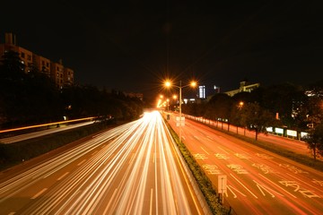 visually impulsive traffic light trails at night, shot on an overpass in shenzhen china