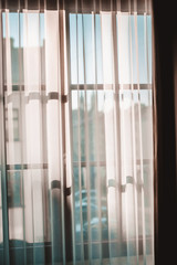 The morning sun through the transparent curtains in the window