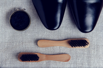 Obraz premium Black classic men's shoes and a set of care for them. Brushes and paste for cleaning shoes.