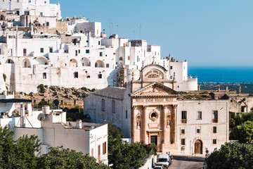 Obraz premium Ostuni, Italy - August 2019: Historic center of white city of Ostuni in Puglia, in a day of August