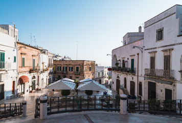Fototapeta na wymiar Ostuni, Italy - August 2019: Historic center of white city of Ostuni in Puglia, in a day of August
