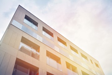 Modern apartment buildings on a sunny day with a blue sky. Facade of a modern apartment building.Glass surface with sunlight.