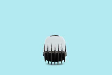 Hair clipper on a pastel blue background. The concept of cutting, improving the appearance. Going to the hairdresser, cutting hair at home. Taking care of appearance.