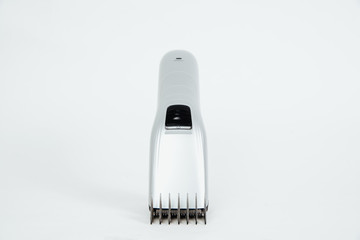 Hair clipper isolated on a white background. The concept of cutting, improving the appearance. Going to the hairdresser, cutting hair at home. Taking care of appearance.