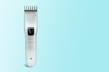 Hair clipper on a pastel blue background. The concept of cutting, improving the appearance. Going to the hairdresser, cutting hair at home. Taking care of appearance.