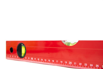Red spirit level isolated on a white background. The concept of building a house, doing home renovations. Getting the right level, attention to detail.