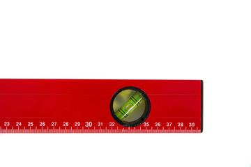Red spirit level isolated on a white background. The concept of building a house, doing home renovations. Getting the right level, attention to detail.