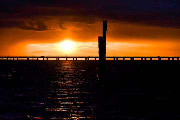 Fototapeta premium sunset over bridge on a lake
