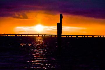 sunset over bridge on a lake