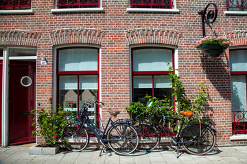Fototapeta na wymiar Two bicycles parked on street. Common scene in Amsterdam Netherlands