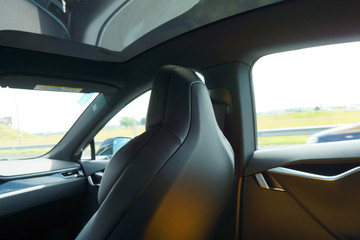 car interior fragment with front seat made of black leather