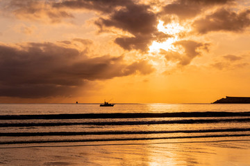 a beautiful sunrise on the beach of La Salve, in Laredo, cantabria