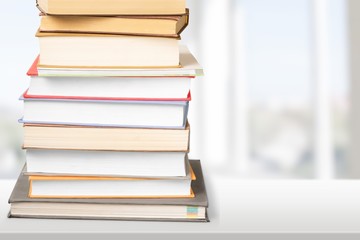 Colorful books collection on background.