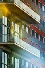 balconies and windows on the facade of a modern multi-storey building, blurred background