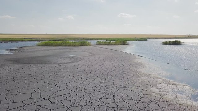 Drone Flying Over Cracked Earth And Water