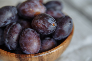 Plums macro in wood plate
