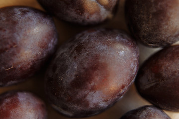 Plums macro in wood plate