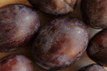 Plums macro in wood plate