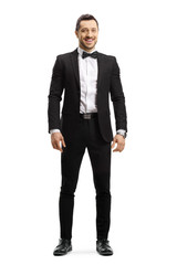 Young man in a suit and bow tie smiling at the camera
