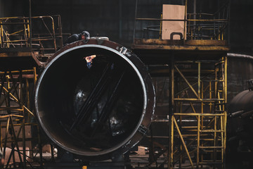 Worker in a dirty and old but still functioning metal works, old fashioned, factory