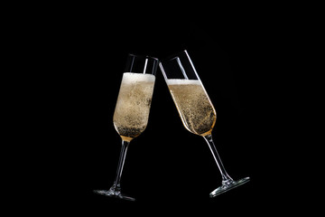 toasting with champagne glasses isolated on black background