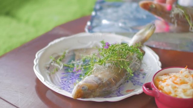 Woman preparing fish in the kitchen.