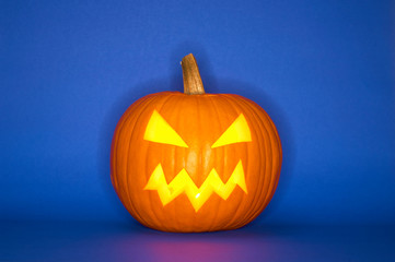 Halloween pumpkin head jack isolated on blue background