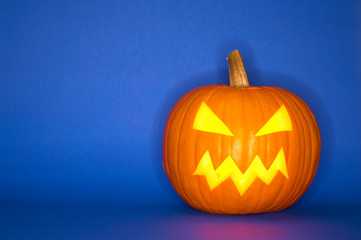 Halloween pumpkin head jack isolated on blue background