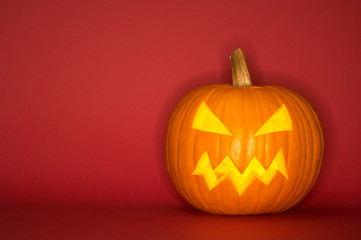 Halloween pumpkin head jack isolated on red background
