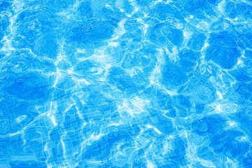 Fototapeta premium Water in swimming pool with sun reflection