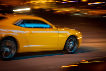 Fototapeta na wymiar yellow car racing at night