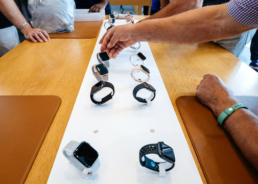 STRASBOURG, FRANCE - SEP 21, 2018: Horizontal image Senior men hand in Apple Store and other customers admiring the new latest Apple Watch Series 4 wearable smartwatch