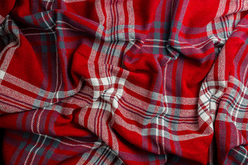 Crumpled red and blue knitted plaid.