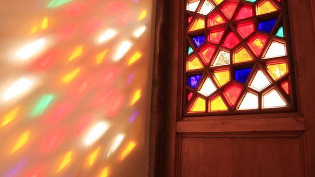 Beautiful stained glass windows with sunlight in the background