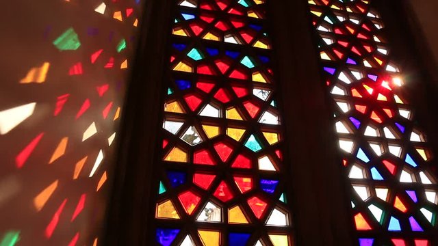 Beautiful stained glass windows with sunlight in the background
