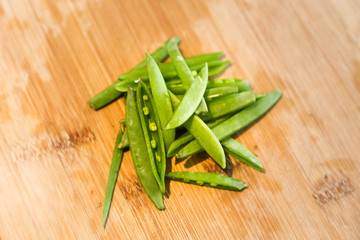 Cut snap peas or snow peas on a chopping board