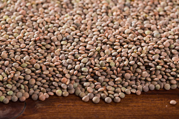 Raw lentil  background  on wooden  surface,  nutritious food